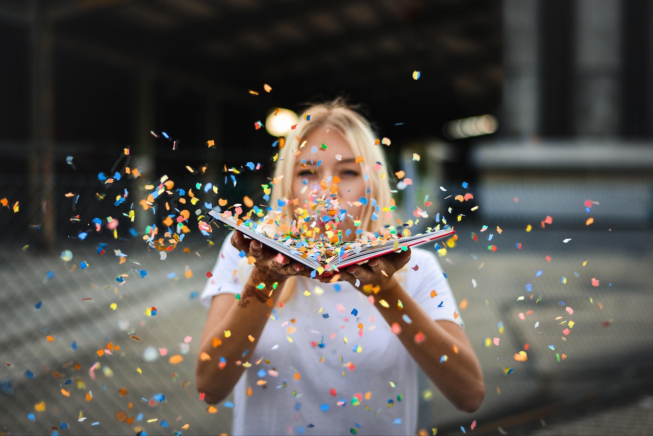 happy holidays, woman, confetti, sparkles, blonde, fun, celebration, cheerful, joy, book, blow, female, portrait